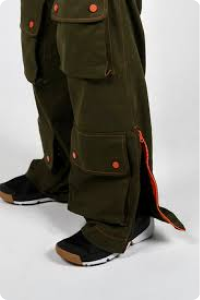 Dark green cargo pants with orange buttons on pockets and zip at ankle